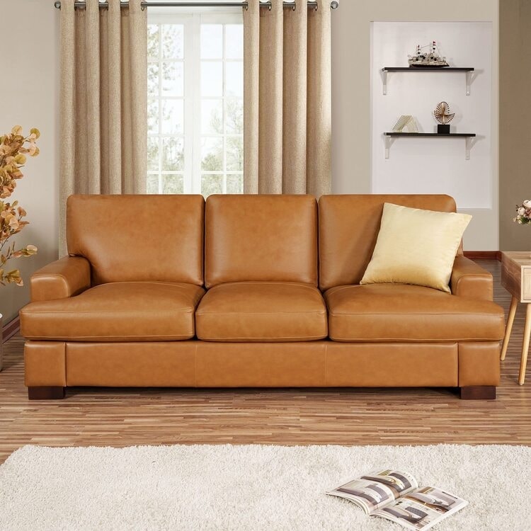Canapé moderne en cuir véritable avec pieds en bois et coussin traversin supplémentaire